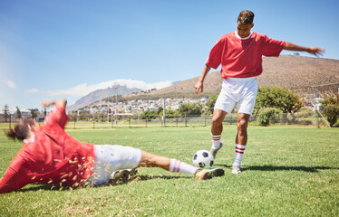 Men, soccer and slide tackle in sports fitness, training and exercise on the field outdoors....