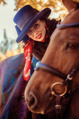 Fototapeta na wymiar Girl in a hat on a horse