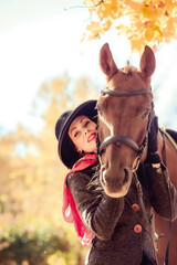 Obraz premium Girl in a hat on a horse
