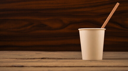 Paper Straw in a Paper Cup on Wooden Table