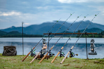 A fishing reel is placed on the edge of a reservoir, waiting for the fish to come and eat their bait, October 22, 2022.