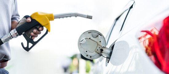 Filling car with gas fuel at station pump