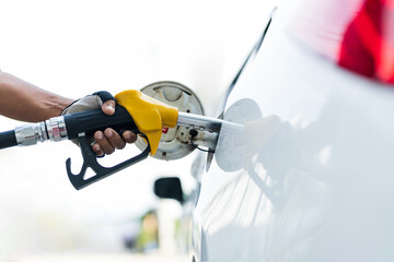 Filling car with gas fuel at station pump
