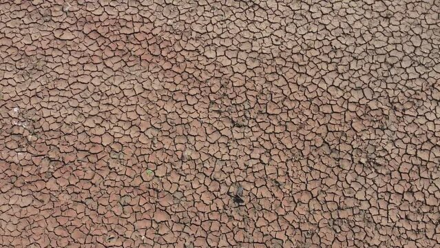 Flying over the drought with drone, dried soil from top view.