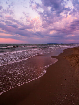 Purple sunset on the sandy beach - Rimini, Italy