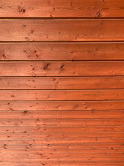 Fototapeta premium Background image of red horizontal wooden boards with small nails descending from top to bottom, perspectiv