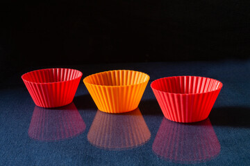 Soft cupcake baking pans on a glass table