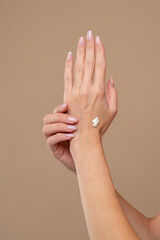 Close up of female hand applying cream