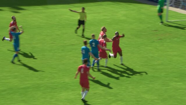 Football Championship: Red Team Forward Shots Penalty, Kicks the Ball and Scores the Goal. Goalkeeper Fails to Catch Ball. Winning the Match and Game, Players Celebrate Tournament Victory
