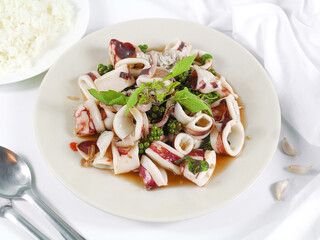 Asian food, Stir Fried Squid with Basil on white plate.