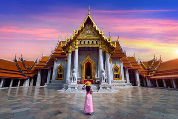 Tourists walking at Wat Benchamabophit or the Marble Temple in Bangkok, Thailand.