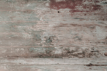 Background of old faded wood texture with paint remains 