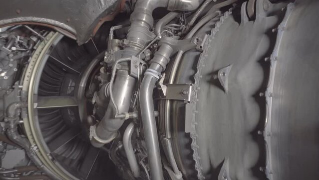 Aircraft mechanic repairs an airplane engine at a service station. Passenger plane on regular service in the hangar