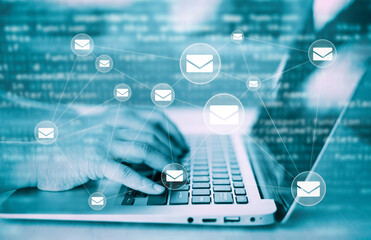 Hand using laptop with communication icons, letter icon, email icons, and newsletter email and...