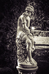 Marble sculpture of a woman in the park. Monochrome