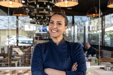 Photo sur Plexiglas Maroc Young north african chef woman smiling on camera at the restaurant - Focus on face