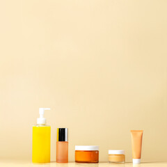 Five step skincare routine concept. Cosmetic product  cleanser, toner, cream, eye serum, spf protection on beige background.