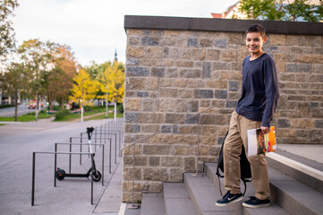 Smiling adolescent boy walking down the steps