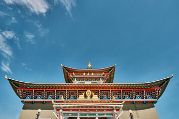 Roofs and visor of entrance door of Buddhist temple. Ivolginsky datsan, Buryatia, Russia.