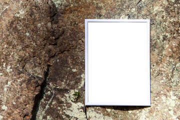 Empty poster frame mockup with copy space, text or art space on rock texture background