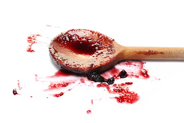Blueberry jam in wooden spoon, marmalade smeared isolated on white, side view
