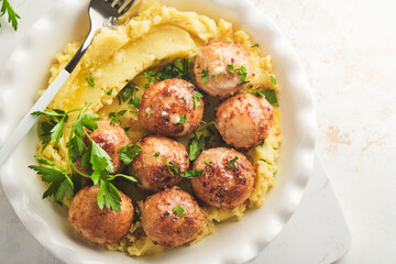 Swedish meatballs in cream sauce, potatoes and lingonberry sauce in bowl on slate, stone or concrete backgrounds. Swedish cuisine. Delicious creamy mashed potatoes. Top view.