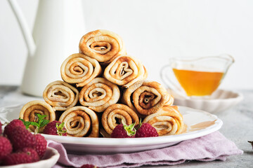 Pancakes. Stack of crepes or thin pancakes with berries, with raspberries and honey for breakfast. Homemade breakfast. Copy space. Selective focus.
