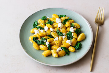 Pumpkin gnocchi with spinach and white cheese. Healthy eating. Vegetarian food.