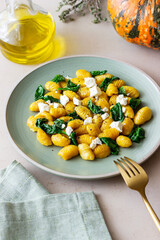 Pumpkin gnocchi with spinach and white cheese. Healthy eating. Vegetarian food.