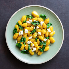 Pumpkin gnocchi with spinach and white cheese. Healthy eating. Vegetarian food.
