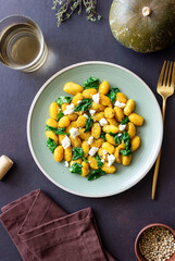 Pumpkin gnocchi with spinach and white cheese. Healthy eating. Vegetarian food.