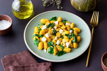 Pumpkin gnocchi with spinach and white cheese. Healthy eating. Vegetarian food.