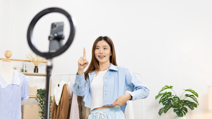 Beautiful woman with a social media influence is greeting the audience for recording vlog video live streaming, Online fashion clothing business, Using psychology to generate interest in customers.