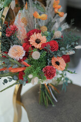 Moden wedding decoration indoors with multi floral ambience. Orange accent flowers. White and Orange theme wedding ceremony. Intimacy family dinners. 