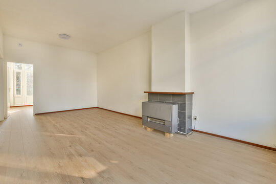 Empty white living room with closed fireplace
