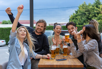 Happy friends drinking beer in a bar
