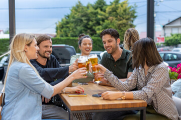 Happy friends drinking beer in a bar