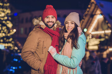 Photo of lovely brunette couple hug wear winter warm cloth on new year fair at street