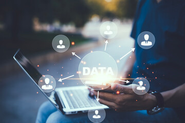 Businessman using a laptop with Analytics and Data Management System on the computer, Hands working on a laptop cloud network graphic overlay, connected to the database. Corporate strategy for finance