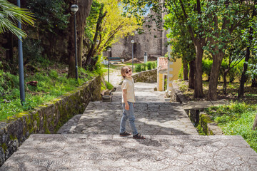 Boy tourist in Herceg Novi old town. Historical and touristic center of Herceg Novi. Montenegro