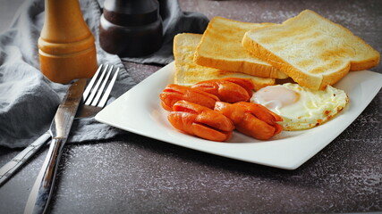 Breakfast, fried eggs, fried sausage and toast.