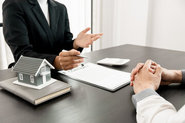 A loan officer is talking to a customer about a house leasing contract.