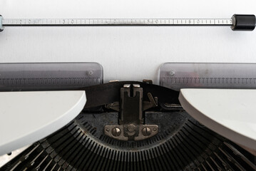 close-up view of blank white paper with copy space in old mechanical typewriter