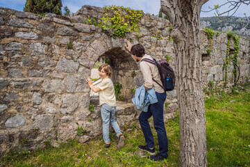 Dad and son tourists walks through the old town of Bar in Montenegro. Happy tourist walks in the mountains. Suburbs of the city of Bar, Montenegro, Balkans. Beautiful nature and landscape