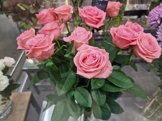 rose flowers stand in a vase in the store