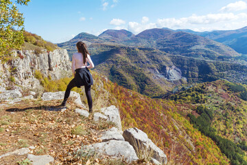 Woman standing high  in the autumn  mountain with stunning panoramic  view . Balkan mountains,  ,Bulgaria