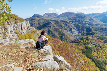 Fototapeta premium Woman standing high in the autumn mountain with stunning panoramic view . Balkan mountains, ,Bulgaria