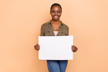 Portrait of positive cheerful lady hold empty space list presentation isolated on beige color background