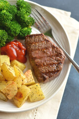 Steak with potatoes and broccoli
