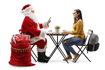 Santa Claus talking to a female student and sitting at a cafe table